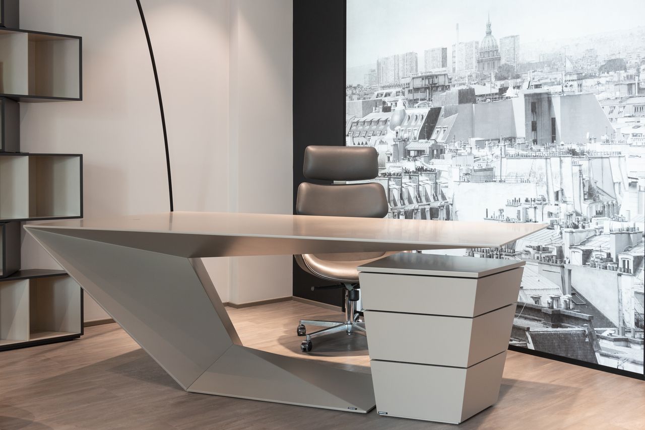services-02 Interior of contemporary office with comfortable chair and futuristic table near cupboard against wall with printed wallpaper
